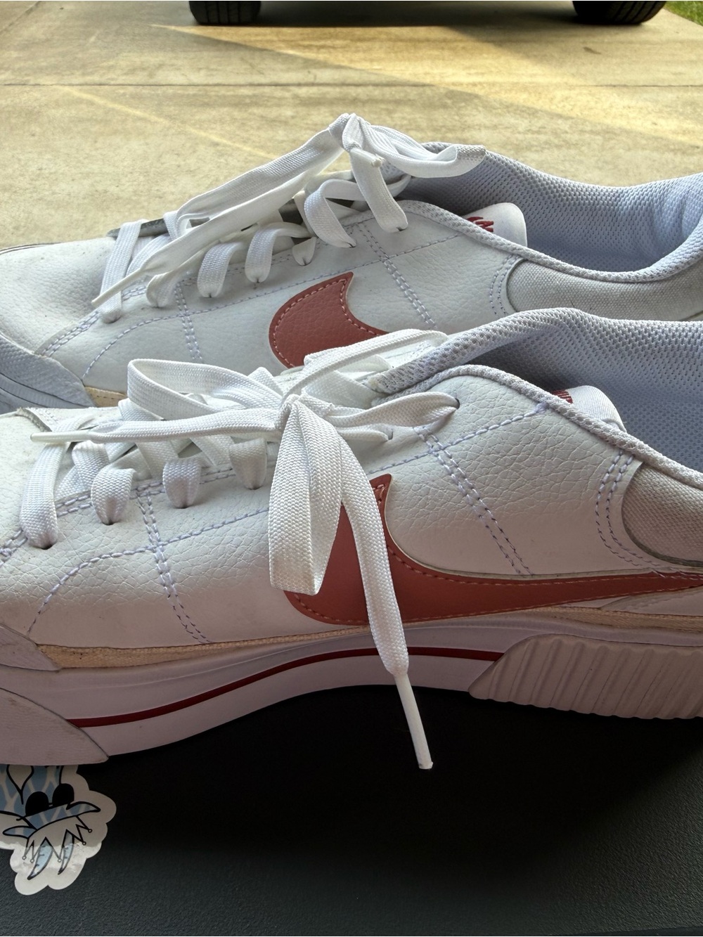 Nike Women's White Sneakers with Pink Swoosh Accent